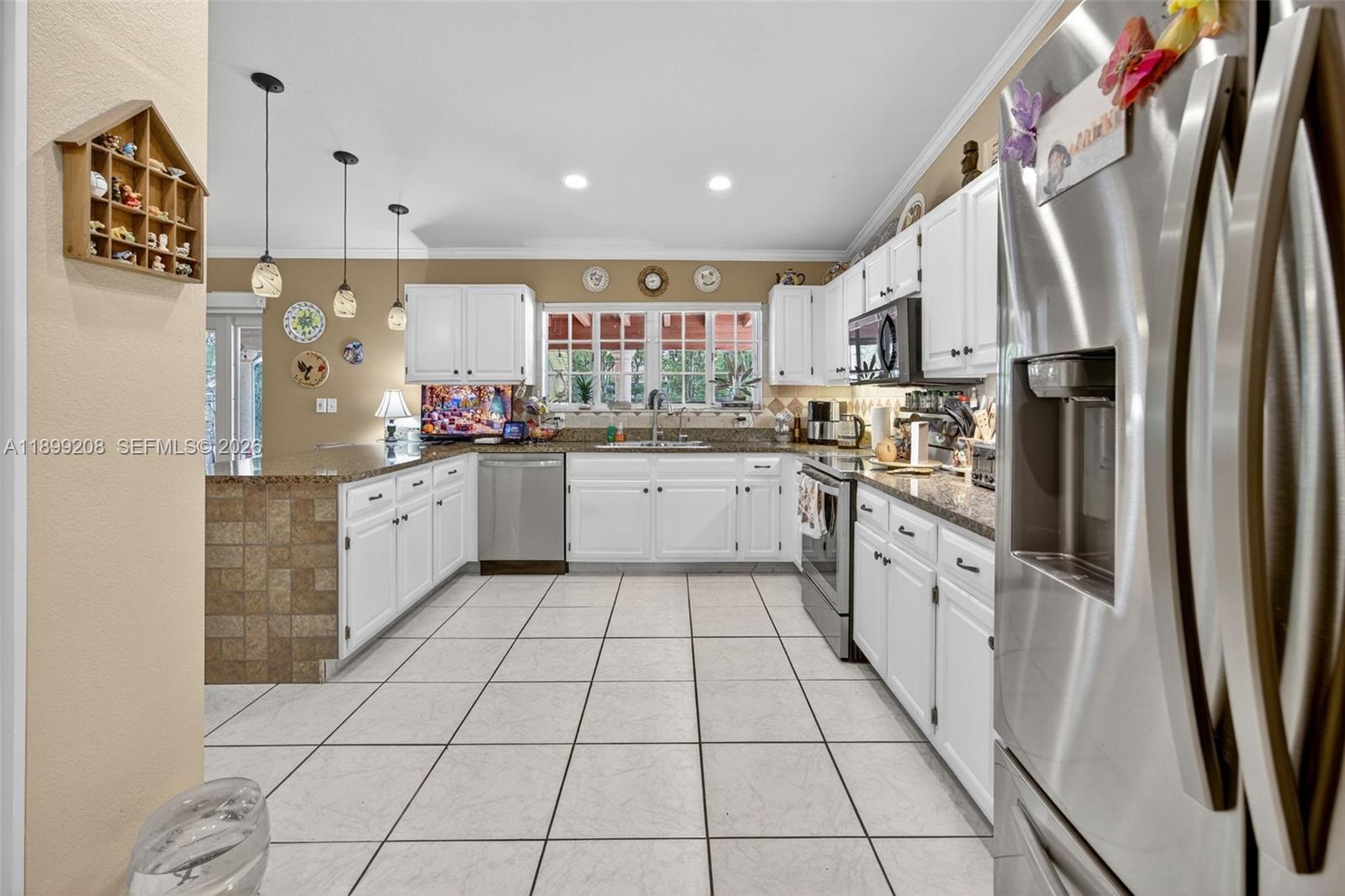 28241 Southwest 157th Court Homestead, FL 33033 - Photo 12 of 52 a kitchen with stainless steel appliances a sink stove and cabinets