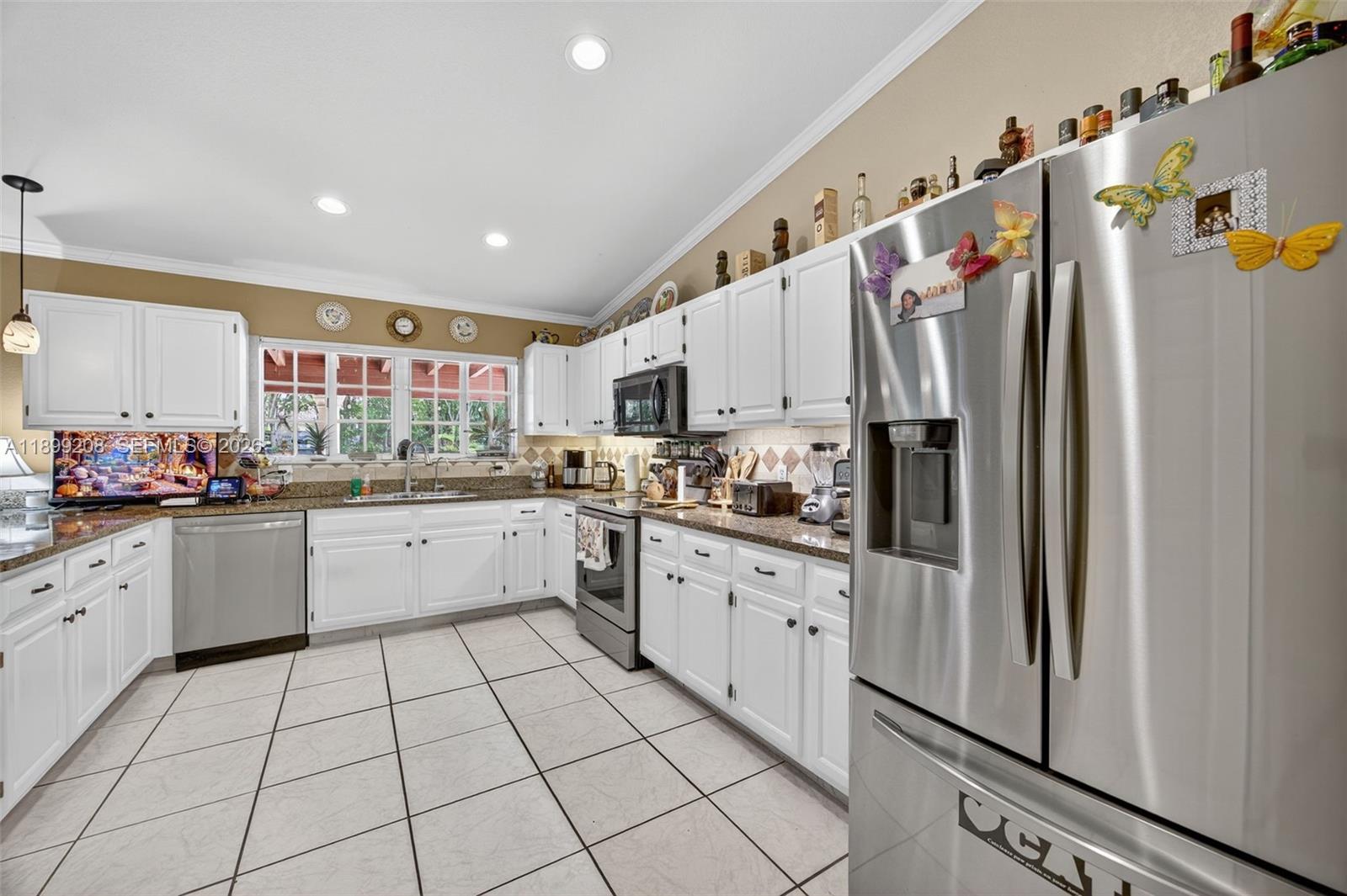28241 Southwest 157th Court Homestead, FL 33033 - Photo 13 of 52 a kitchen with stainless steel appliances granite countertop a refrigerator and a sink