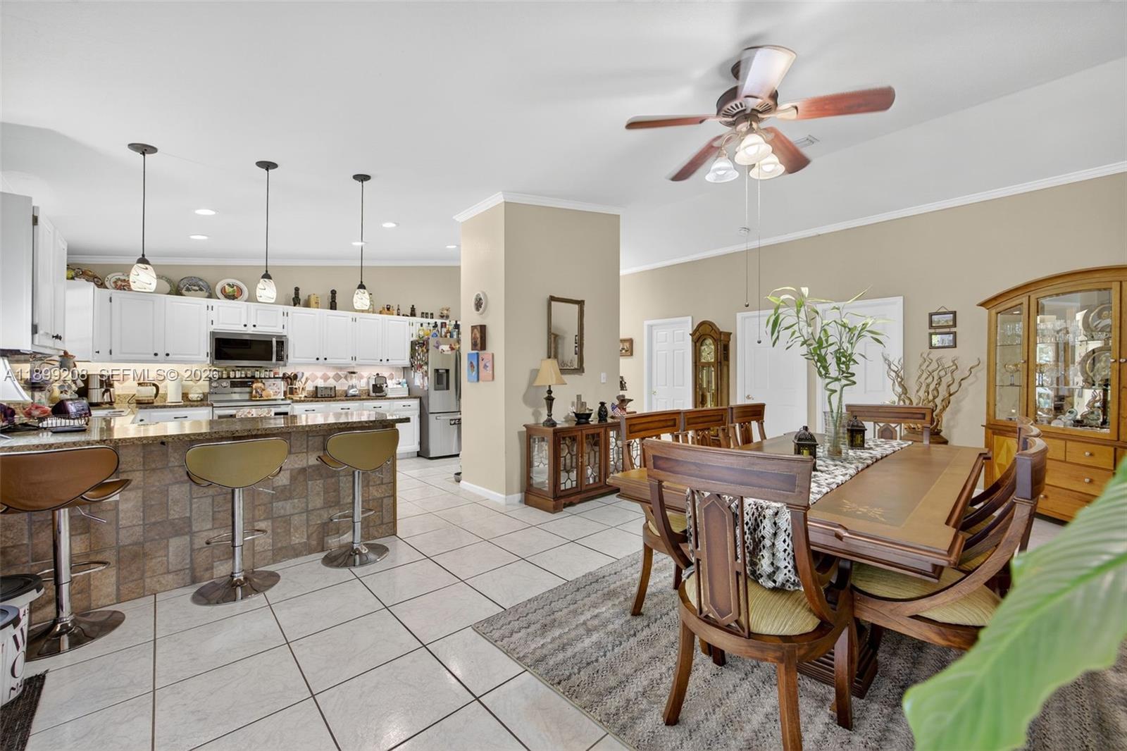 28241 Southwest 157th Court Homestead, FL 33033 - Photo 16 of 52 a room with stainless steel appliances kitchen island granite countertop furniture and a view of kitchen