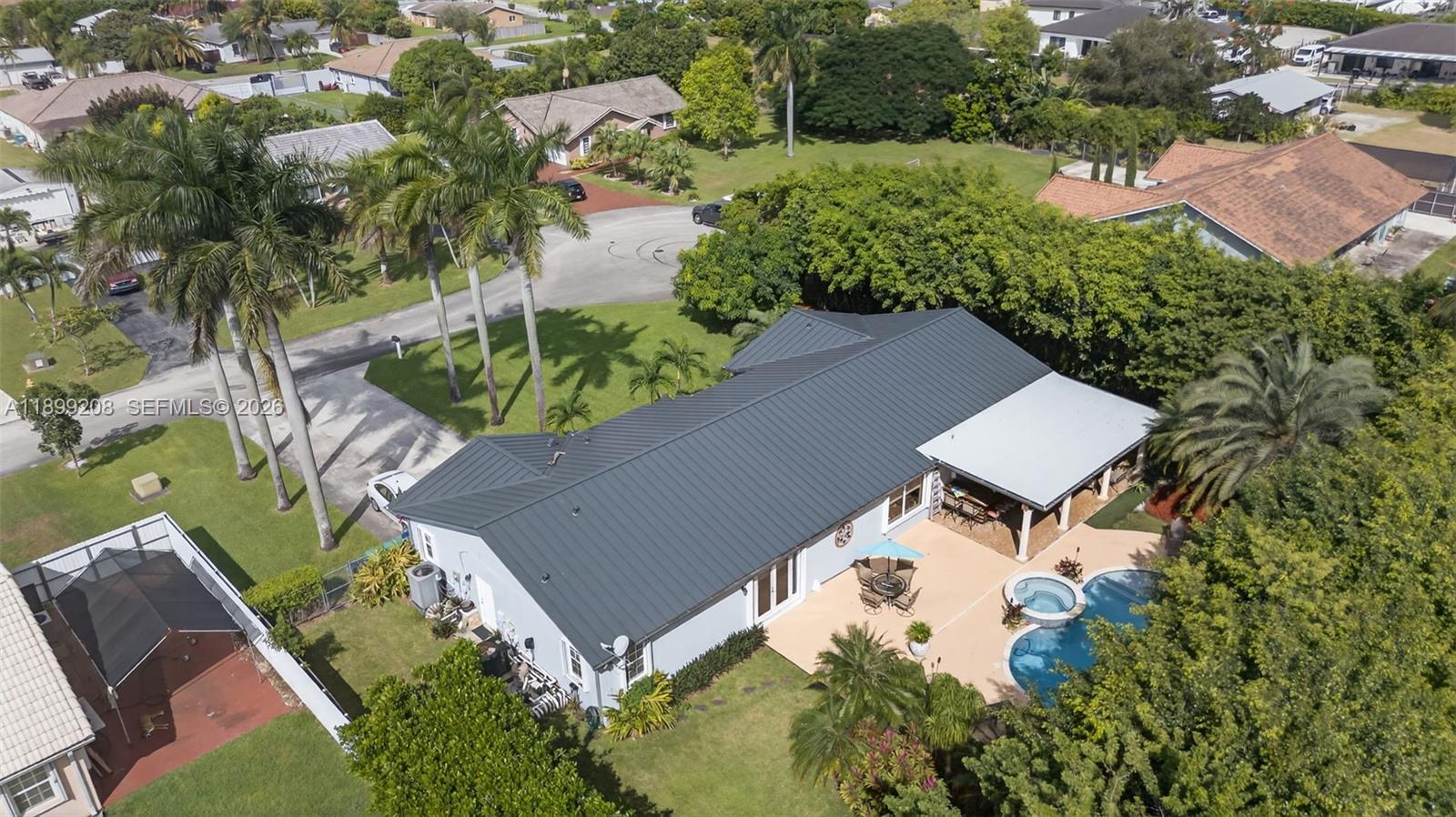 28241 Southwest 157th Court Homestead, FL 33033 - Photo 2 of 52 an aerial view of a house with a yard and lake view