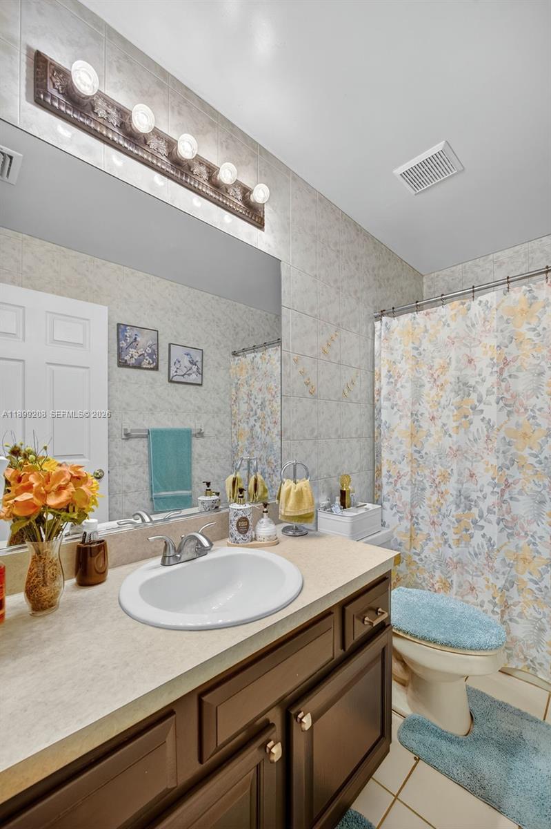 28241 Southwest 157th Court Homestead, FL 33033 - Photo 21 of 52 a bathroom with a sink and a mirror