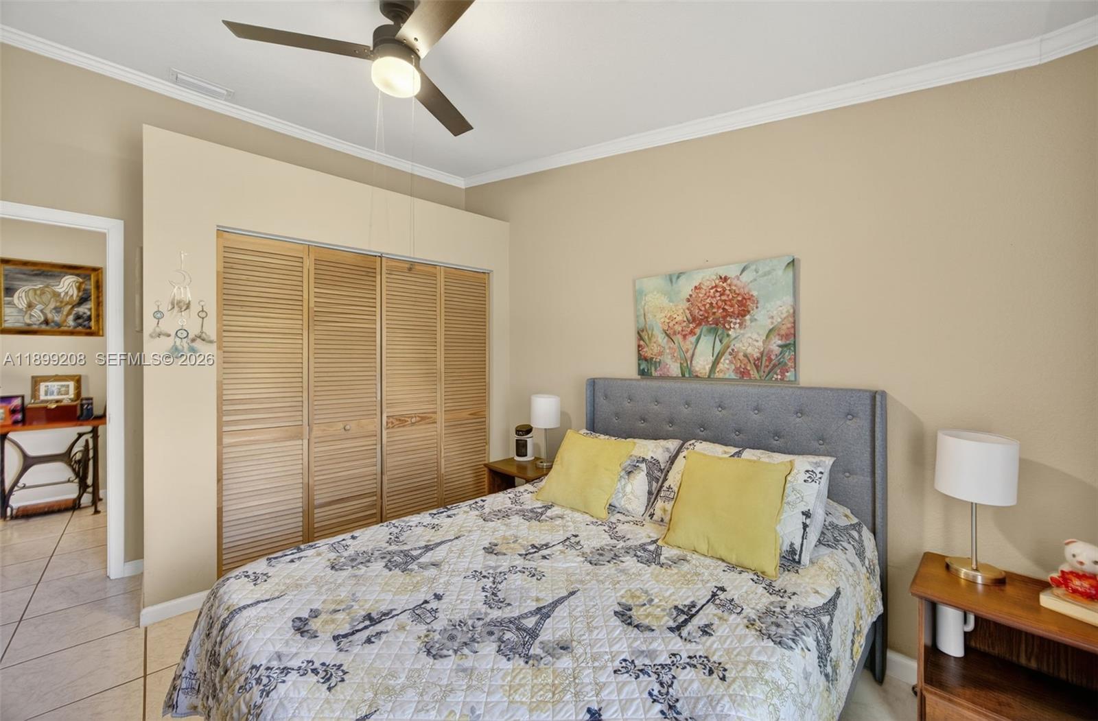 28241 Southwest 157th Court Homestead, FL 33033 - Photo 24 of 52 a bedroom with a bed and a painting on the wall