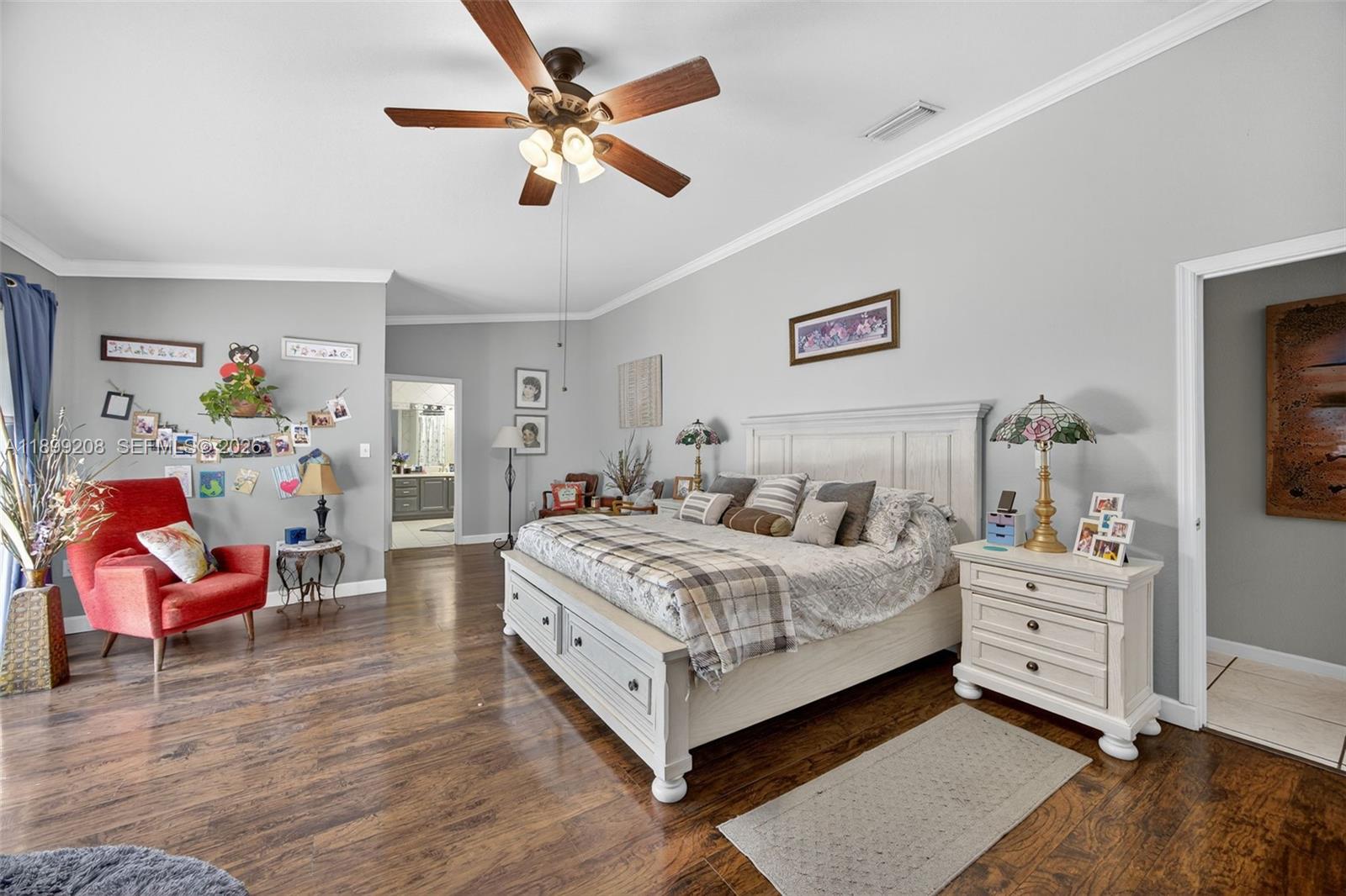 28241 Southwest 157th Court Homestead, FL 33033 - Photo 26 of 52 a bedroom with a bed and a chandelier
