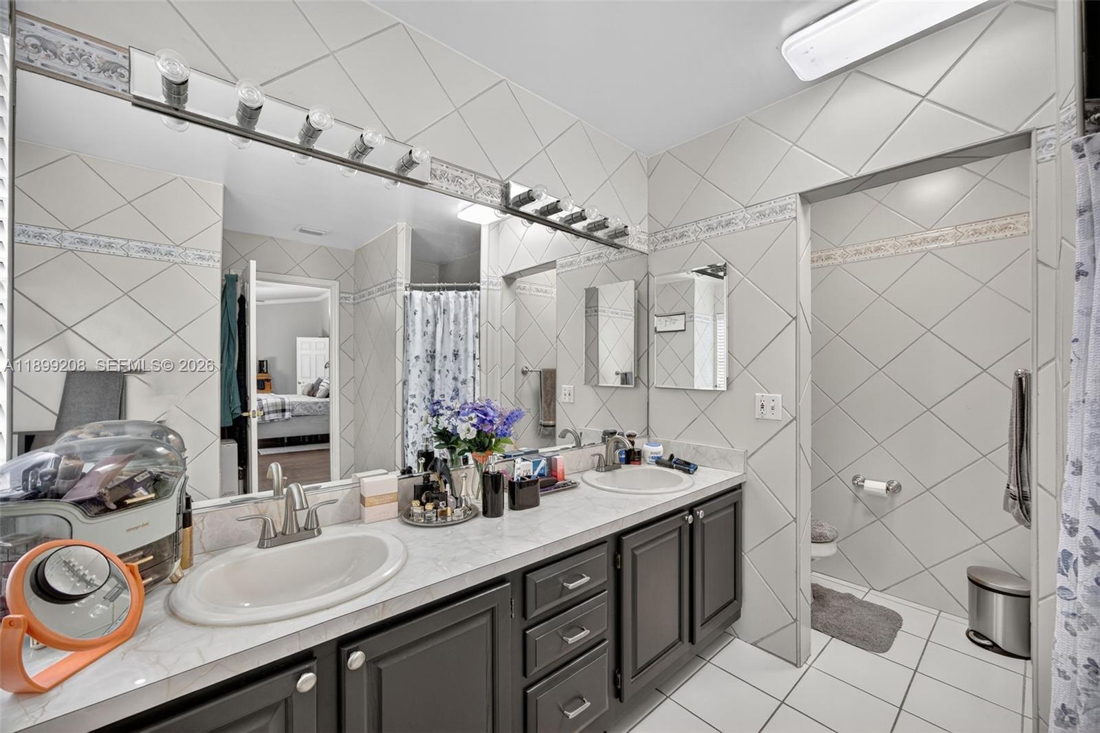 28241 Southwest 157th Court Homestead, FL 33033 - Photo 28 of 52 a bathroom with a double vanity sink mirror and toilet