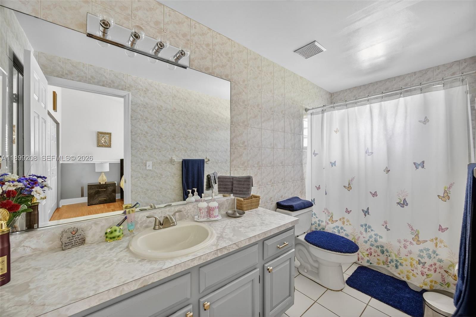 28241 Southwest 157th Court Homestead, FL 33033 - Photo 30 of 52 a bathroom with a granite countertop sink and a mirror