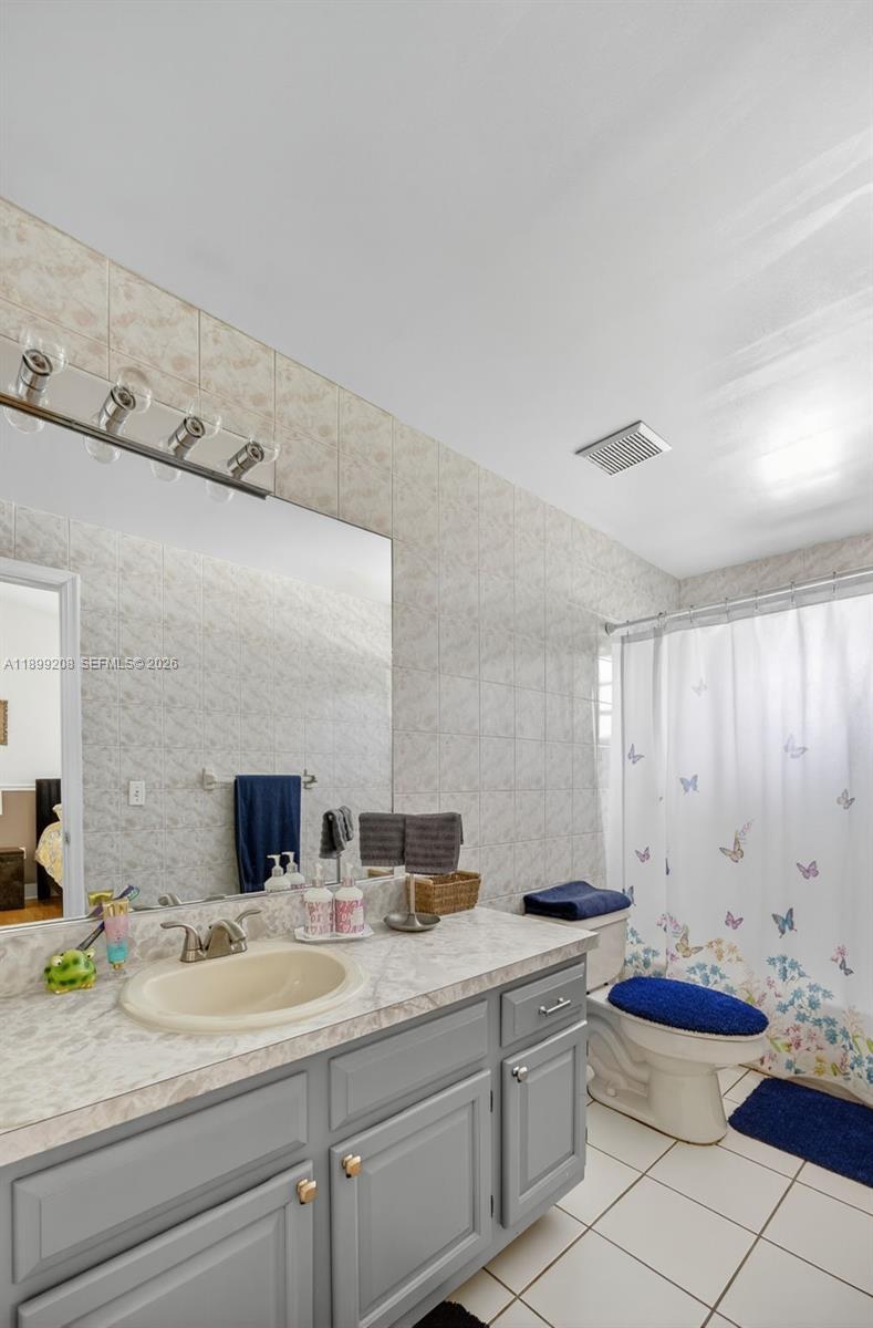 28241 Southwest 157th Court Homestead, FL 33033 - Photo 31 of 52 a bathroom with a granite countertop toilet sink and mirror