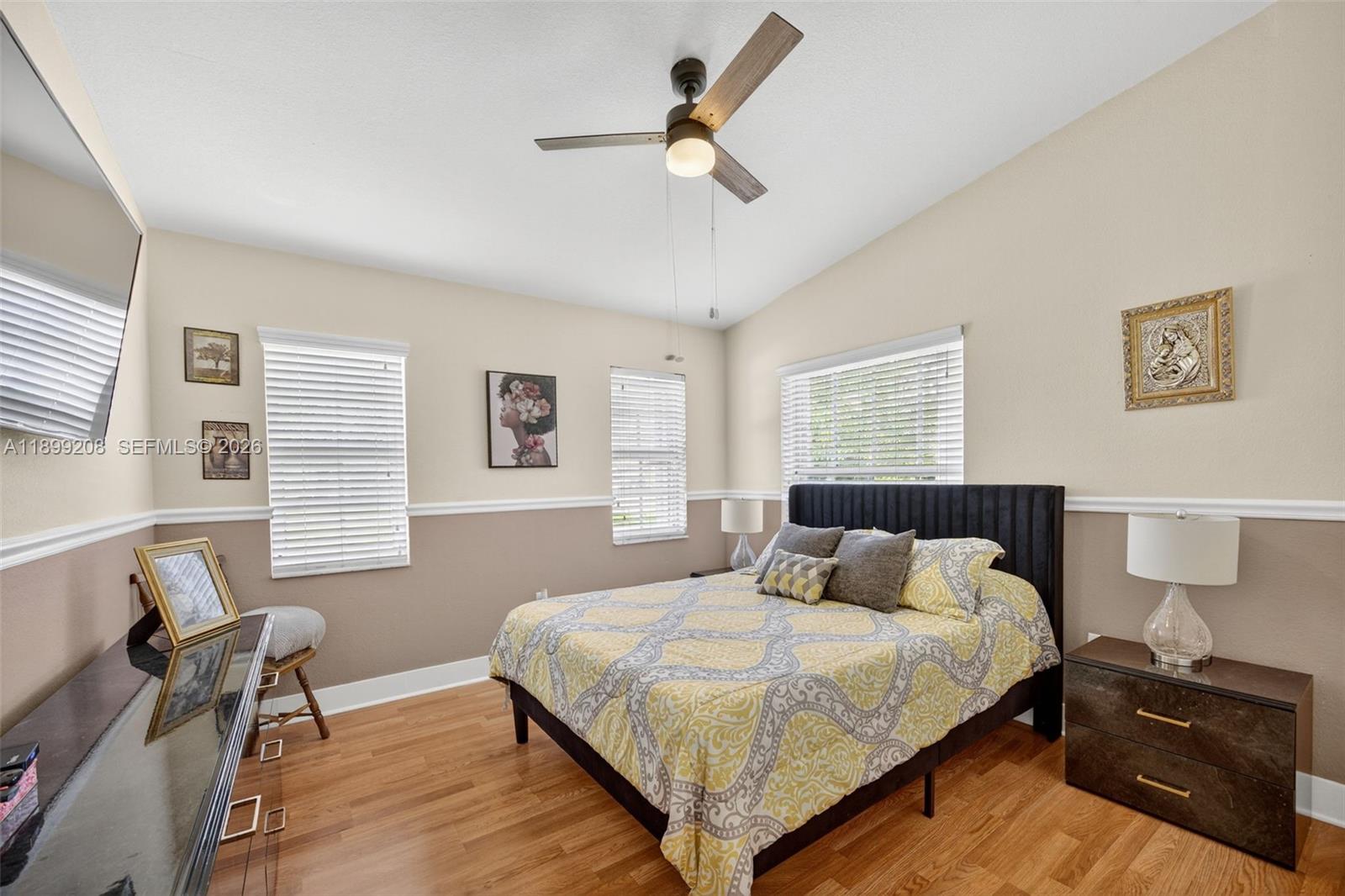 28241 Southwest 157th Court Homestead, FL 33033 - Photo 32 of 52 a bedroom with a bed and wooden floor