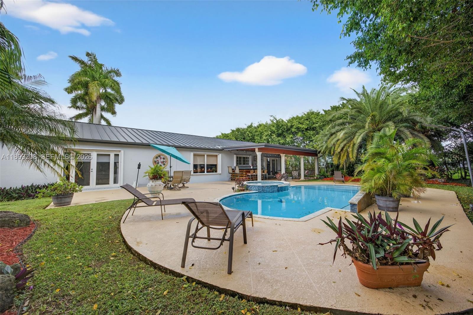 28241 Southwest 157th Court Homestead, FL 33033 - Photo 36 of 52 a view of a house with backyard swimming pool and sitting area