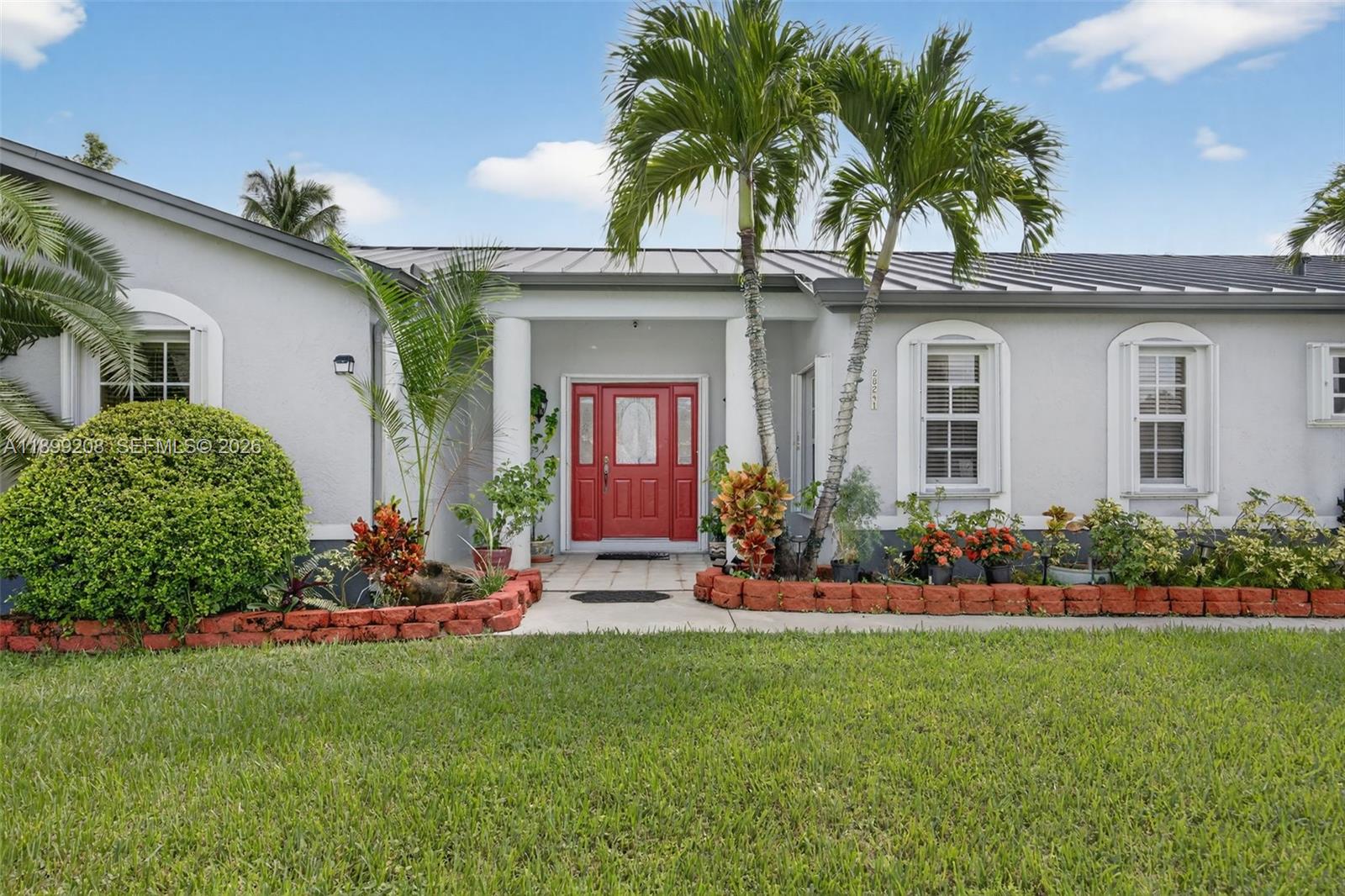 28241 Southwest 157th Court Homestead, FL 33033 - Photo 7 of 52 a front view of house with yard and outdoor seating