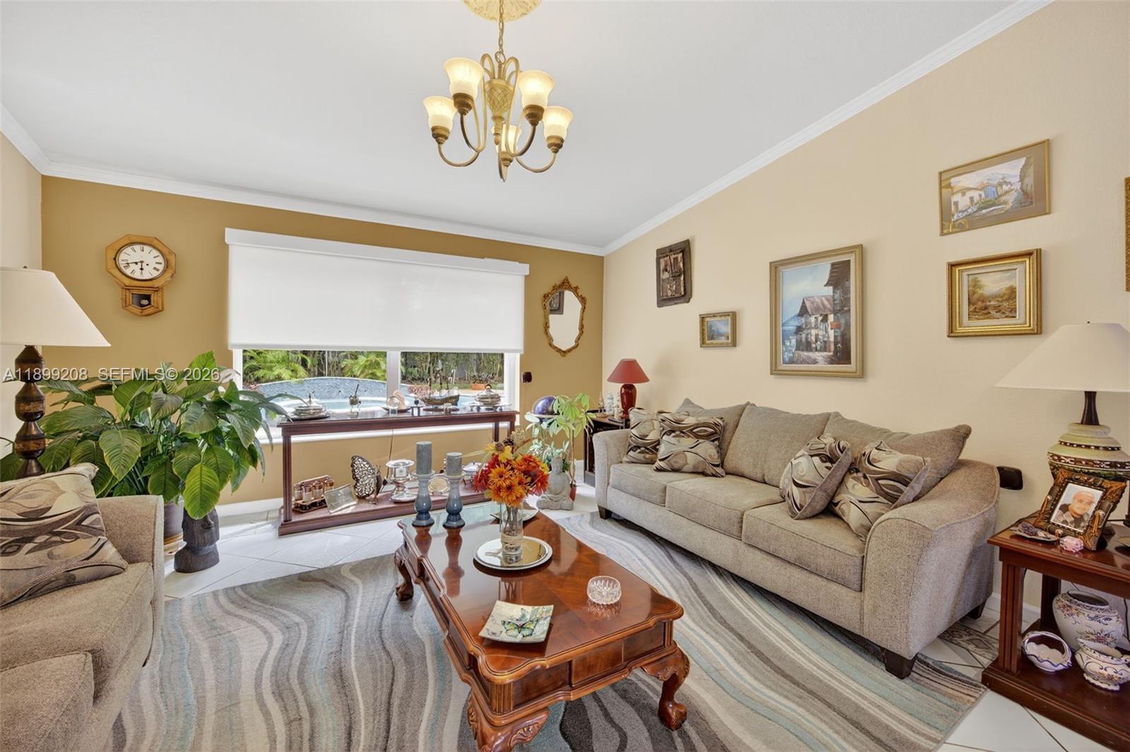 28241 Southwest 157th Court Homestead, FL 33033 - Photo 10 of 52 a living room with furniture a chandelier and a window