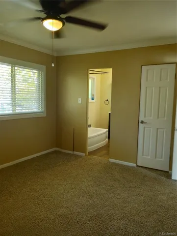 an empty room with windows and cabinet