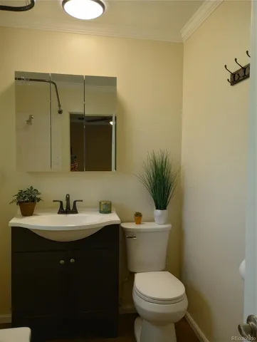 a bathroom with a toilet a sink and mirror