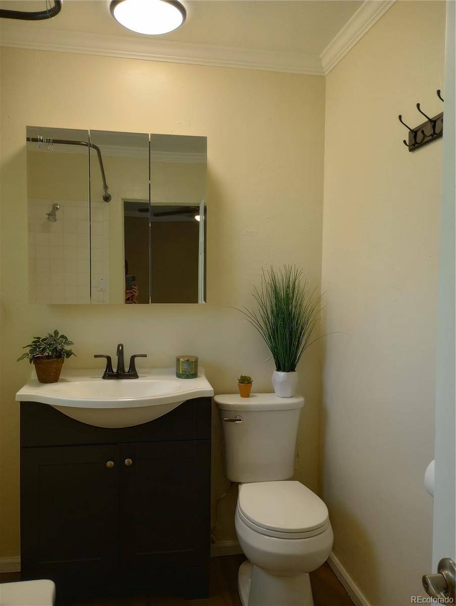 111 Crystal Park Road, Unit 2 Manitou Springs, CO 80829 - Photo 18 of 22 a bathroom with a toilet a sink and mirror