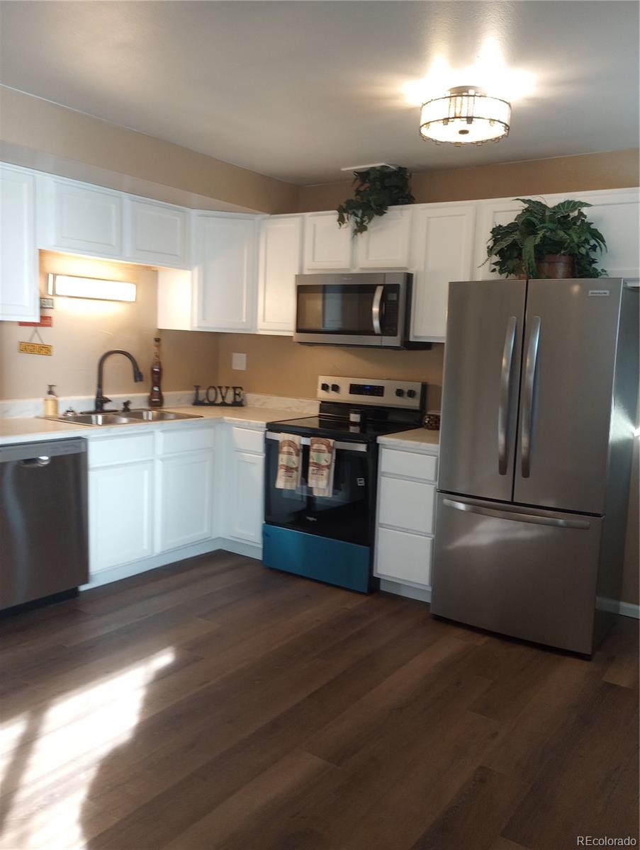 111 Crystal Park Road, Unit 2 Manitou Springs, CO 80829 - Photo 5 of 22 a kitchen with stainless steel appliances granite countertop a refrigerator a stove a sink dishwasher and a refrigerator