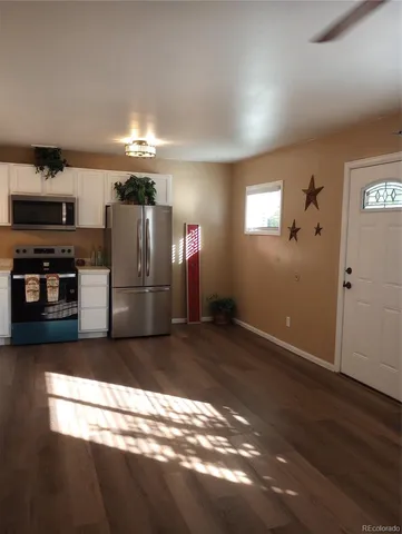 a kitchen with stainless steel appliances a refrigerator and a stove top oven