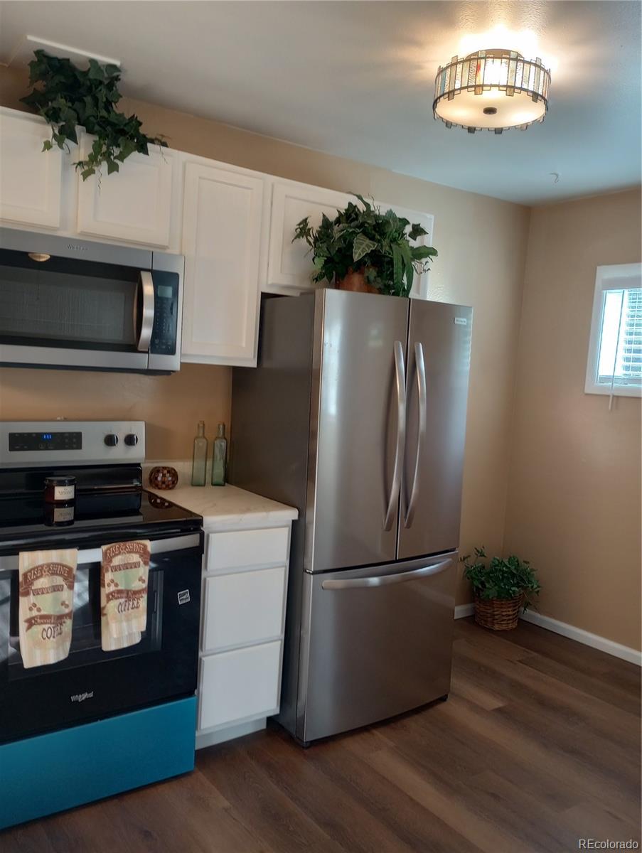 111 Crystal Park Road, Unit 2 Manitou Springs, CO 80829 - Photo 8 of 22 a kitchen with stainless steel appliances granite countertop a refrigerator a stove a sink and a microwave