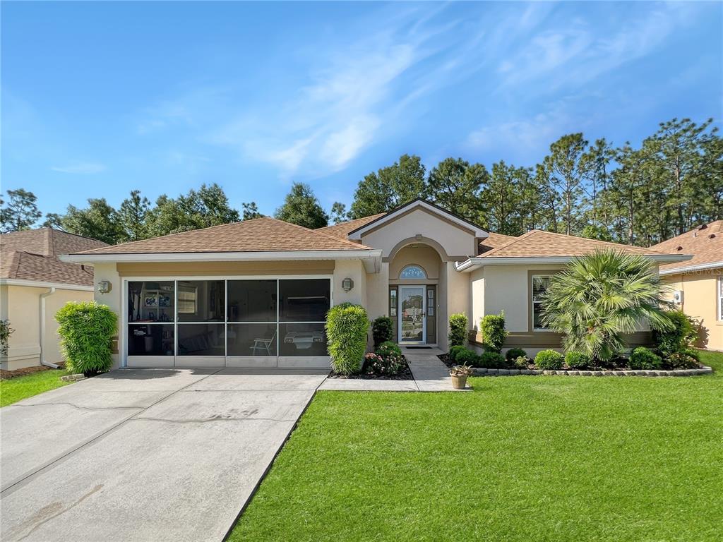 6374 Southwest 117th Loop Ocala, FL 34476 - Photo 1 of 1 a front view of a house with garden