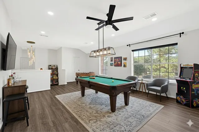 a living room with furniture a rug and a flat screen tv
