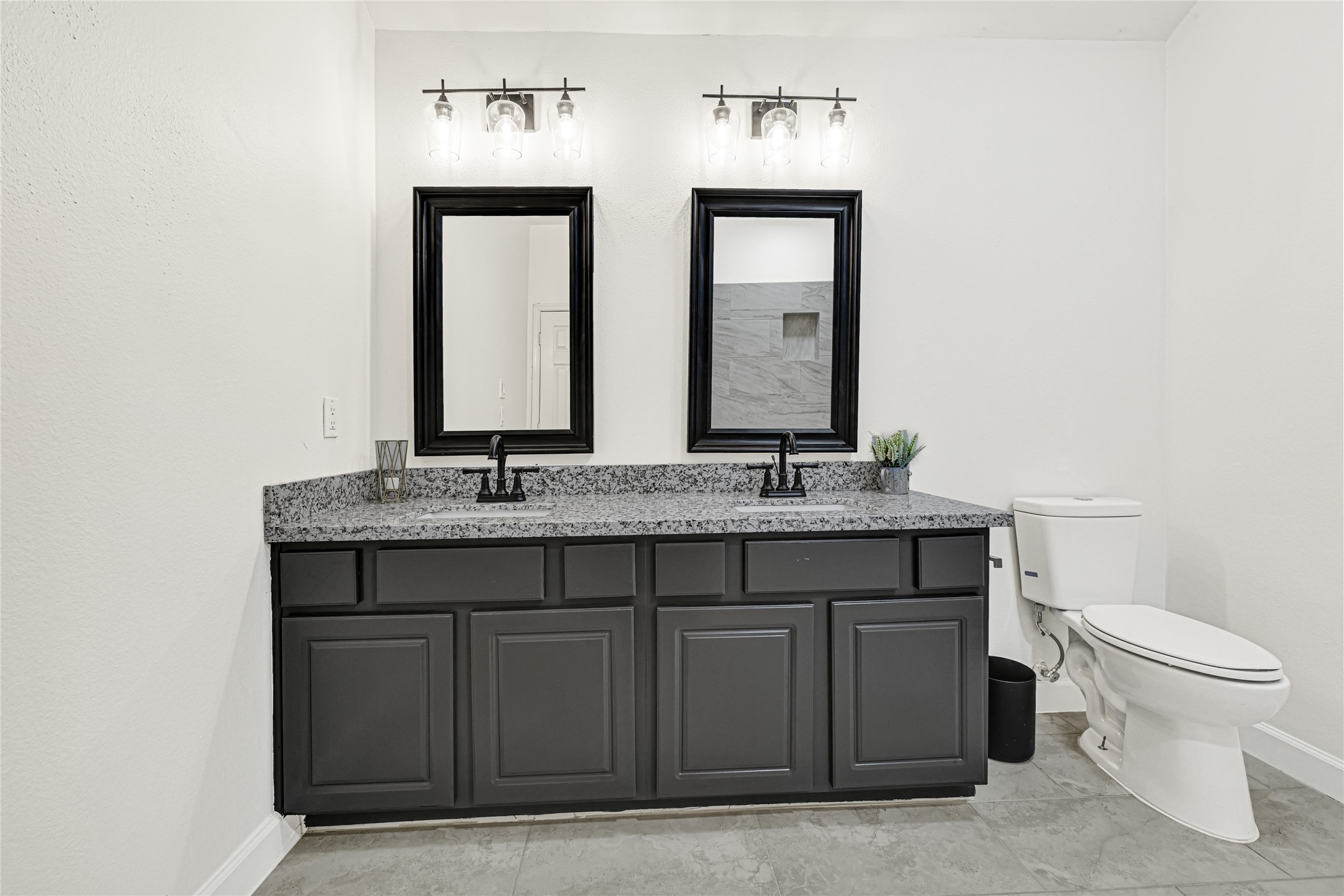 16502 Barker Ranch Court Cypress, TX 77429 - Photo 14 of 21 a bathroom with a granite countertop toilet sink and mirror