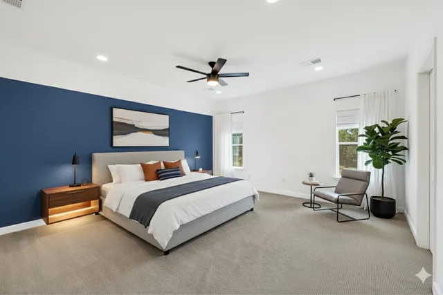 a bedroom with a bed furniture and a potted plant