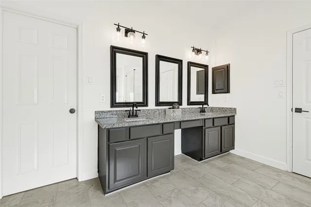 a bathroom with a double vanity sink and a mirror