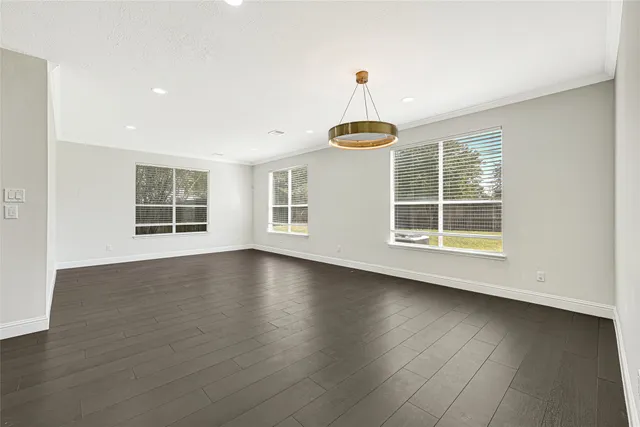 a view of wooden floor and windows in a room