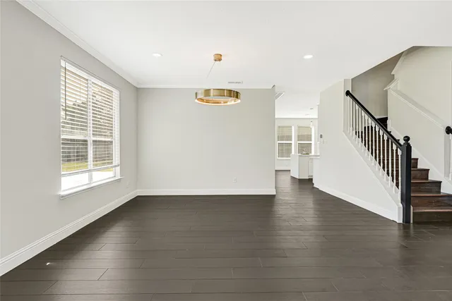 a view of a livingroom with wooden floor and a window