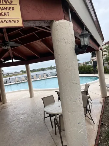 a view of a chairs and table in the back yard