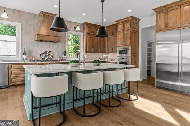 a kitchen with stainless steel appliances a sink and a stove