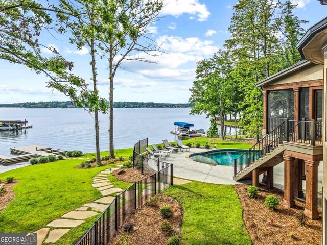 an aerial view of a house with outdoor space and a lake view