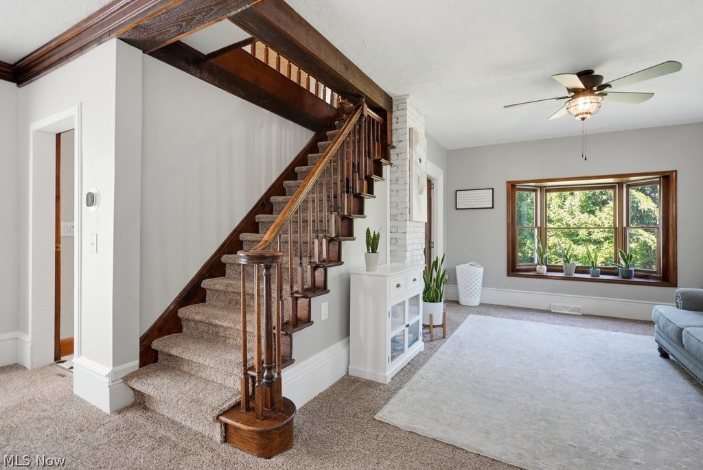 23055 Snell Road Columbia Station, OH 44028 - Photo 20 of 50 Staircase featuring wood balusters and a carpeted tread, set against light gray walls with white trim