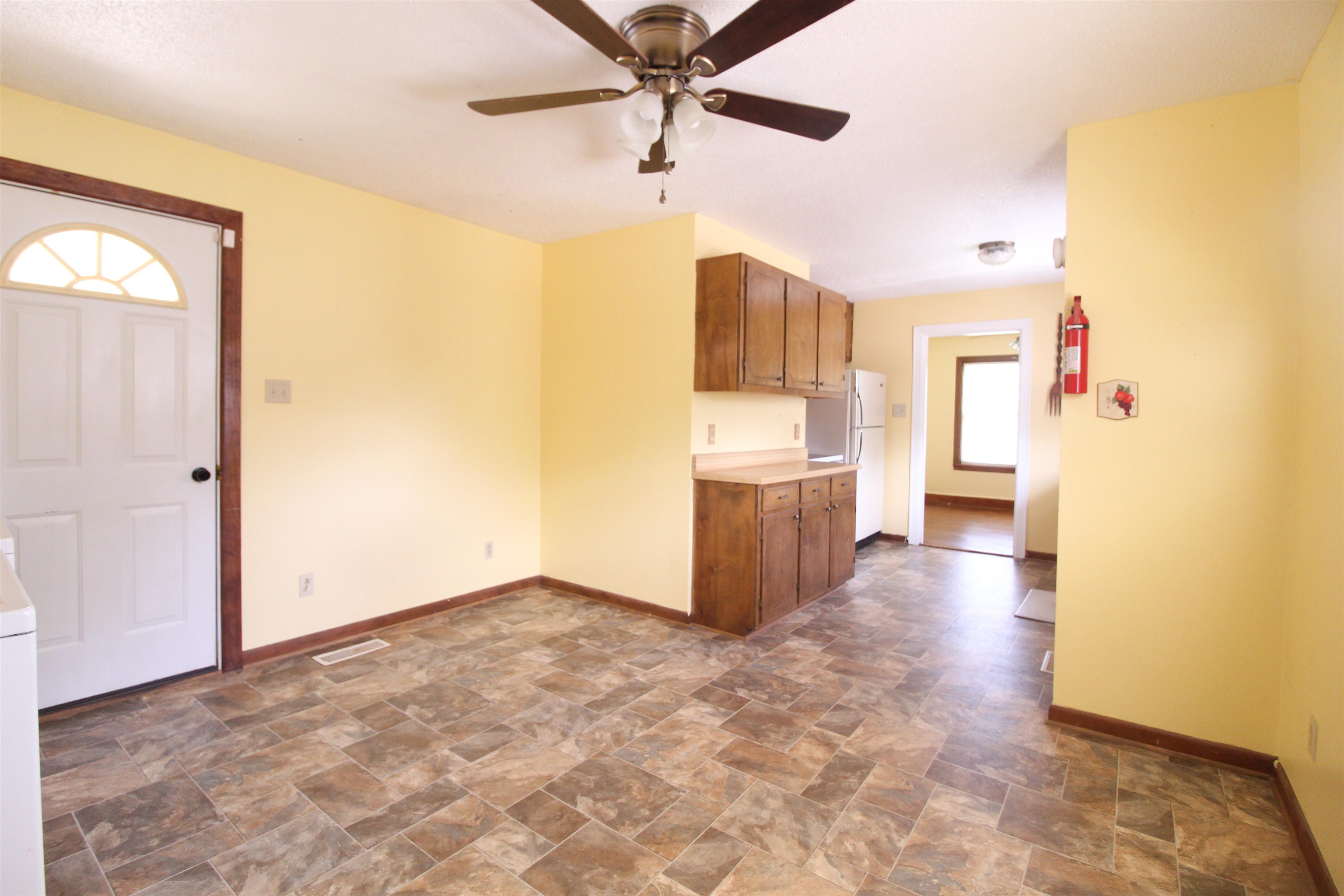 274 Joann Street Ripley, TN 38063 - Photo 12 of 28 a view of a kitchen with wooden cabinet and a ceiling fan
