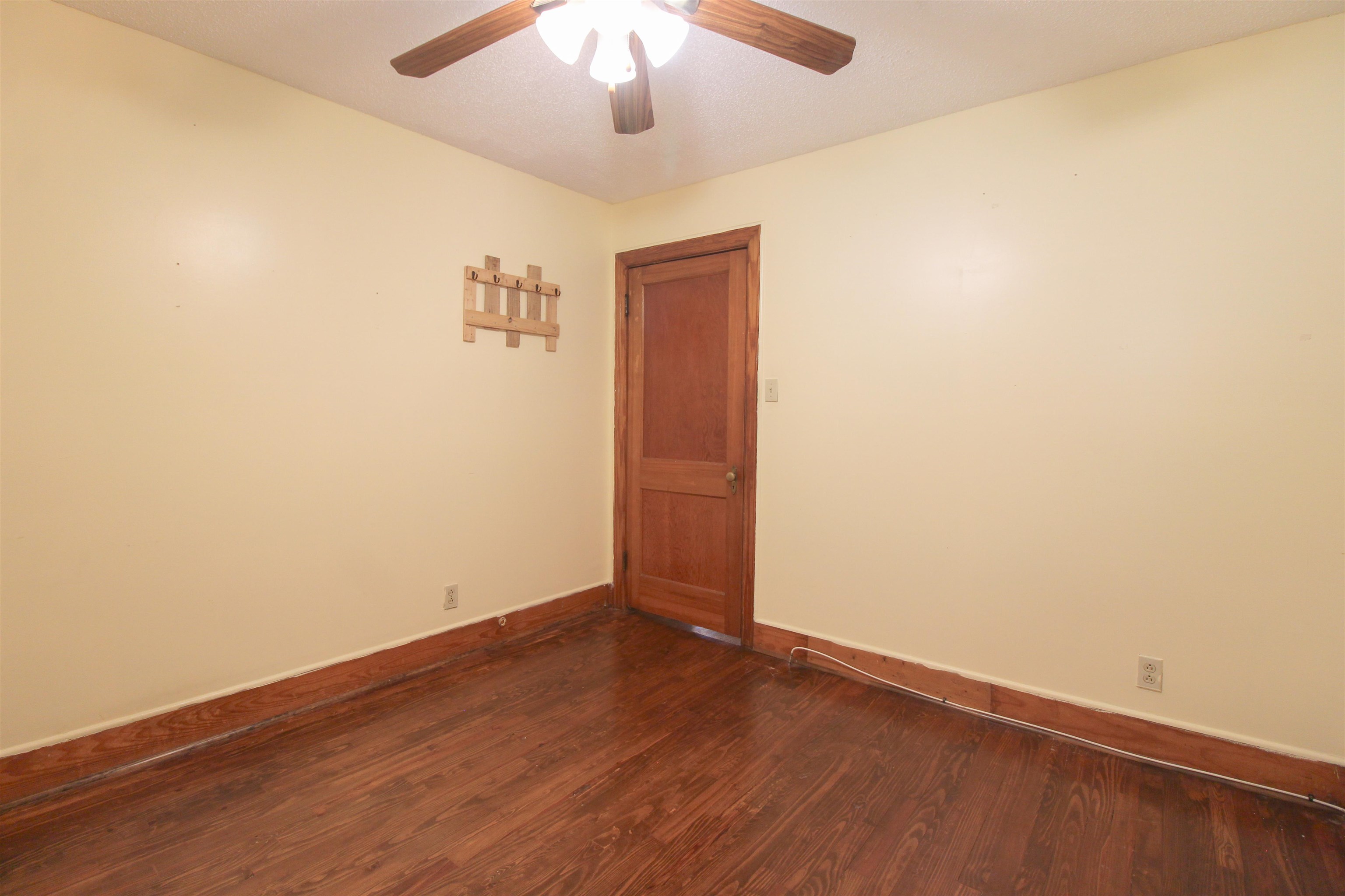 274 Joann Street Ripley, TN 38063 - Photo 22 of 28 an empty room with wooden floor and windows