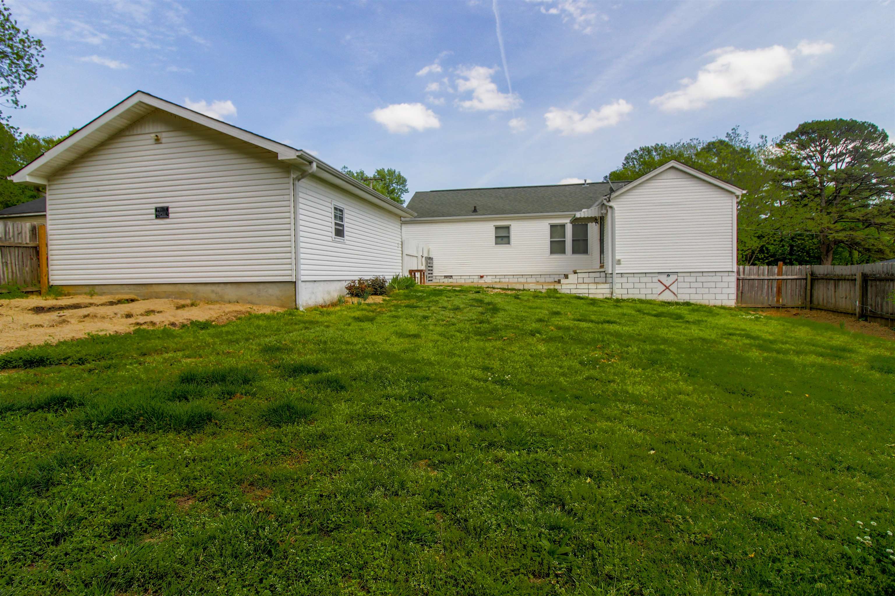 274 Joann Street Ripley, TN 38063 - Photo 27 of 28 a view of a backyard with potted plants and large tree
