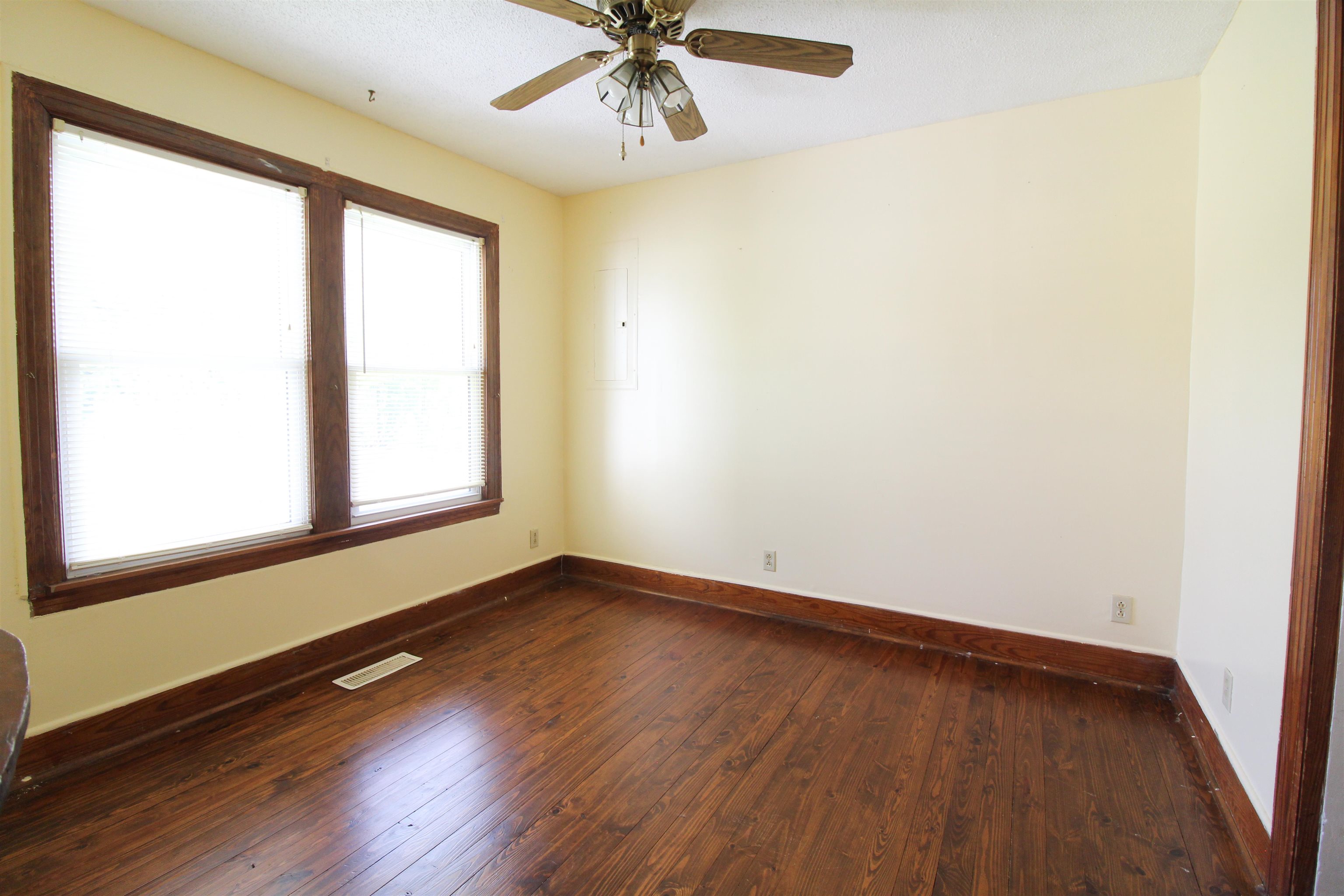 274 Joann Street Ripley, TN 38063 - Photo 8 of 28 an empty room with wooden floor fan and windows