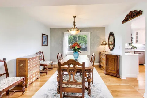 a view of a dining room and hall with furniture