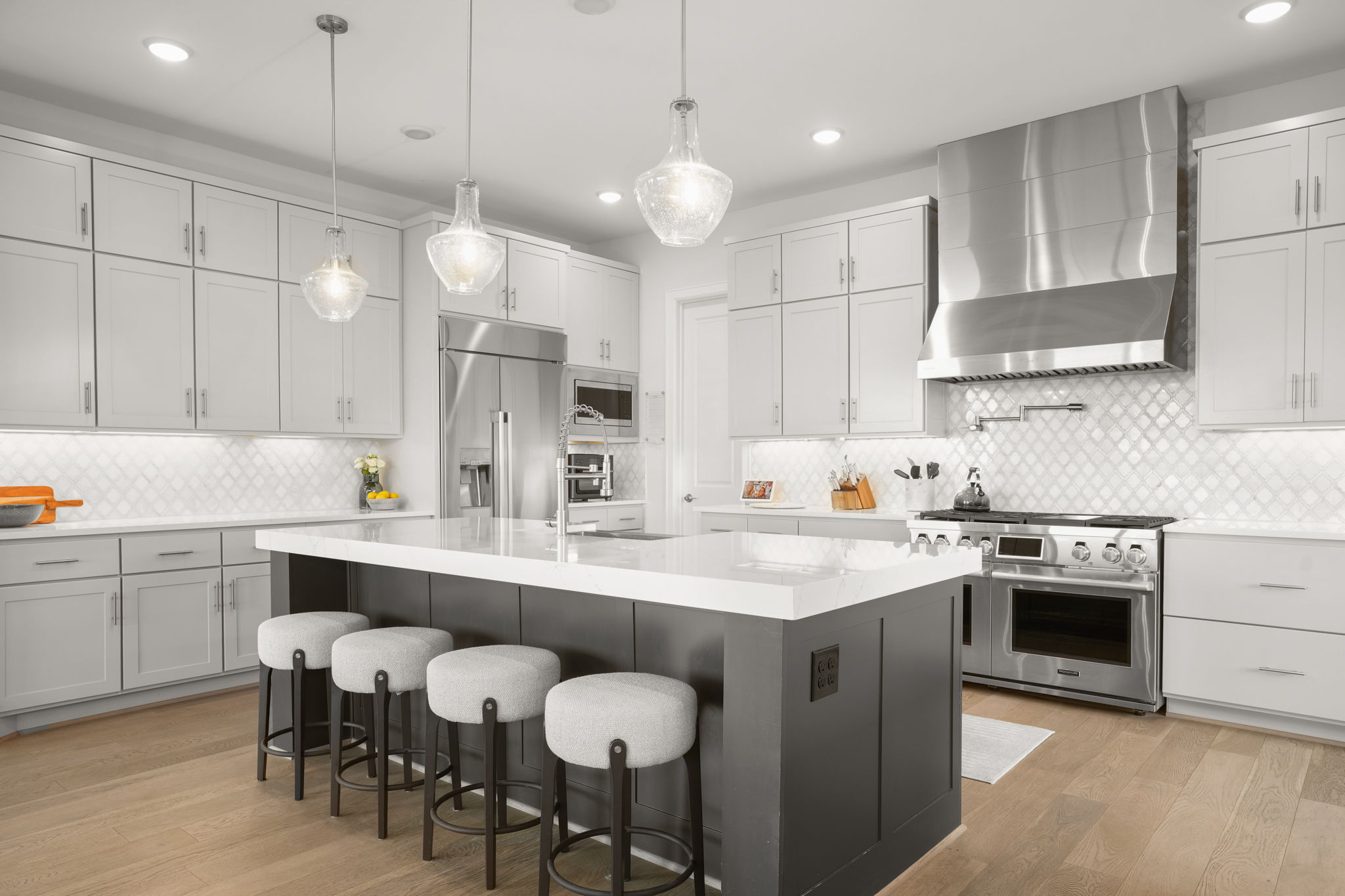 104 Lodestone Cove Austin, TX 78738 - Photo 5 of 40 Culinary excellence awaits with a spacious kitchen island, high-end stainless steel appliances, and abundant cabinet storage.