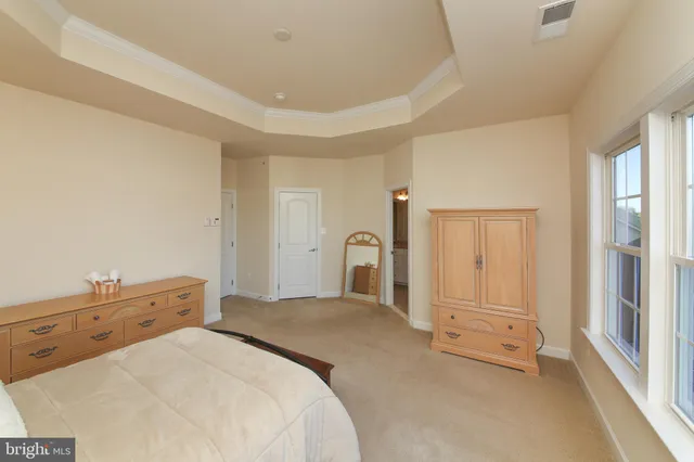 a bathroom with a granite countertop tub sink shower and mirror