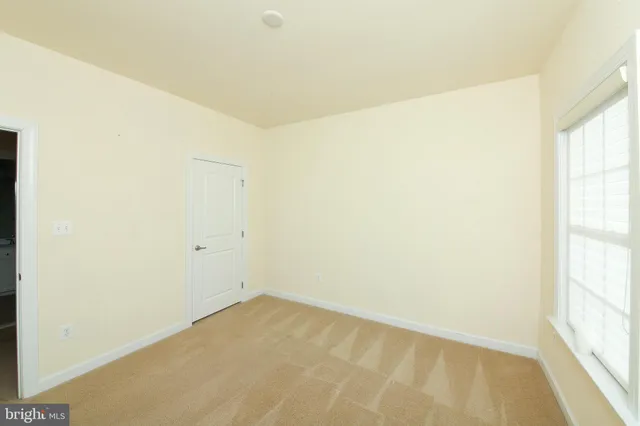 a bedroom with a bed and a chair