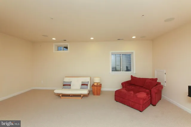 a view of a green field with trees in the background