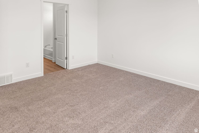 1417 West 2350th South, Unit 14 Perry, UT 84302 - Photo 7 of 19 Neutral-toned carpeting and white walls complement the wide baseboards