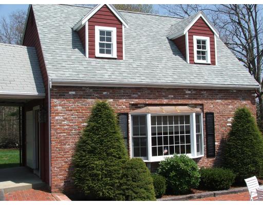 63 Cedarhill Road Holbrook, MA 02343 - Photo 17 of 18 a view of a brick house with large windows and a yard