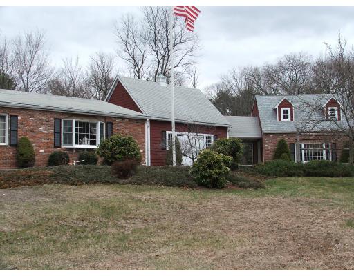 63 Cedarhill Road Holbrook, MA 02343 - Photo 3 of 18 a view of a white house with a yard and plants