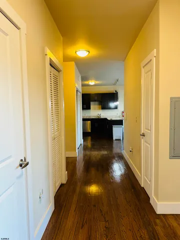a view of a hallway view with wooden floor and staircase