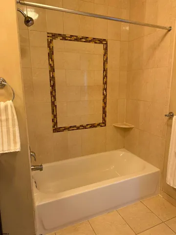 a bathroom with a shower and a bath tub