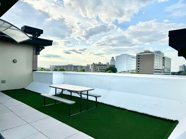 a view of a terrace with a garden and bench