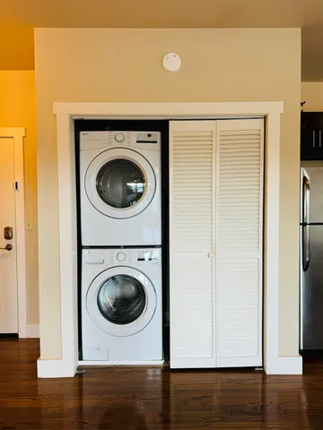 a view of a hallway with washer and dryer
