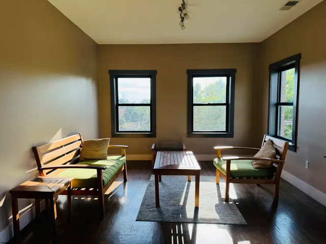 a living room with furniture and wooden floor