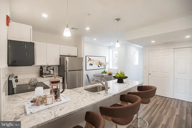 a kitchen with stainless steel appliances kitchen island granite countertop a sink and cabinets