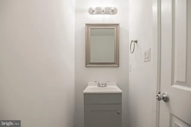a bathroom with a sink a mirror and vanity